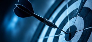 A dart in the bullseye of a target
